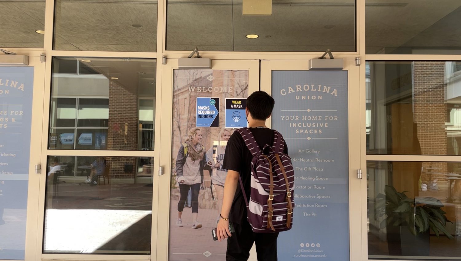 Image of Jerry Xu walking in campus building